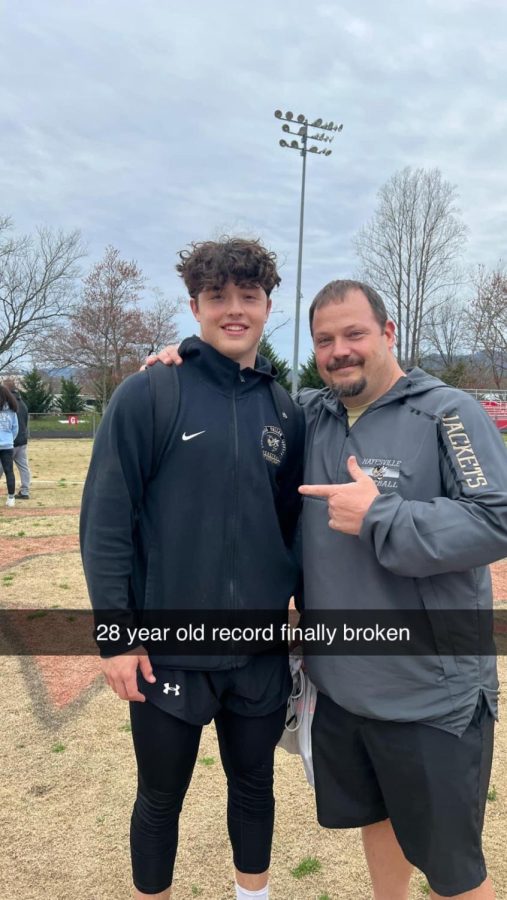 Chad McClure congratulates his son Taylor McClure for his record-breaking throw at the first track meet of the season!