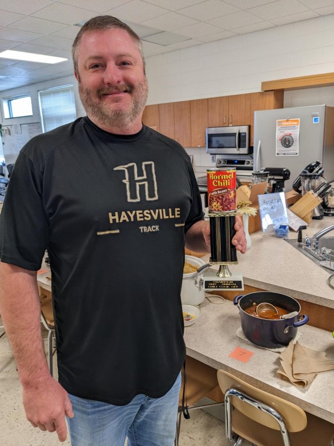 Coach Hensley displays his winning trophy for this year's chili cook-off competition.