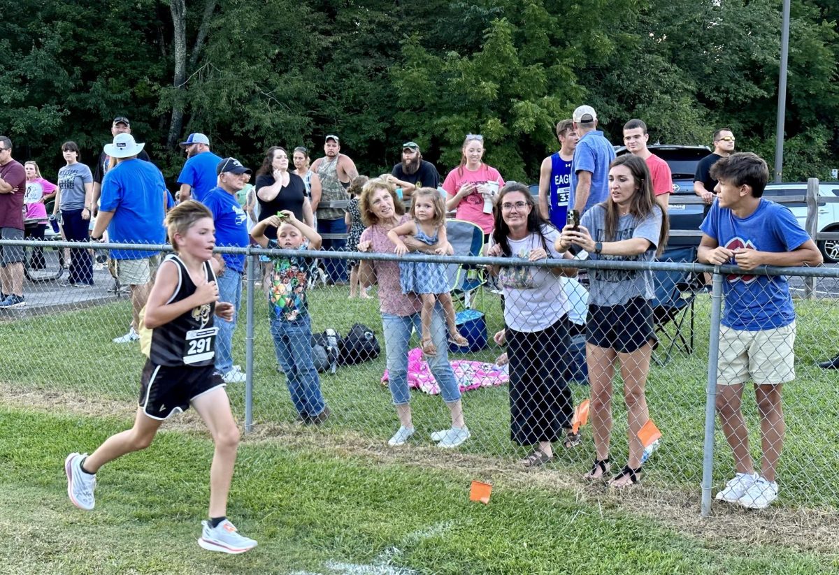 Parker Hughes strides toward the finish line at the HHS XC home meet.